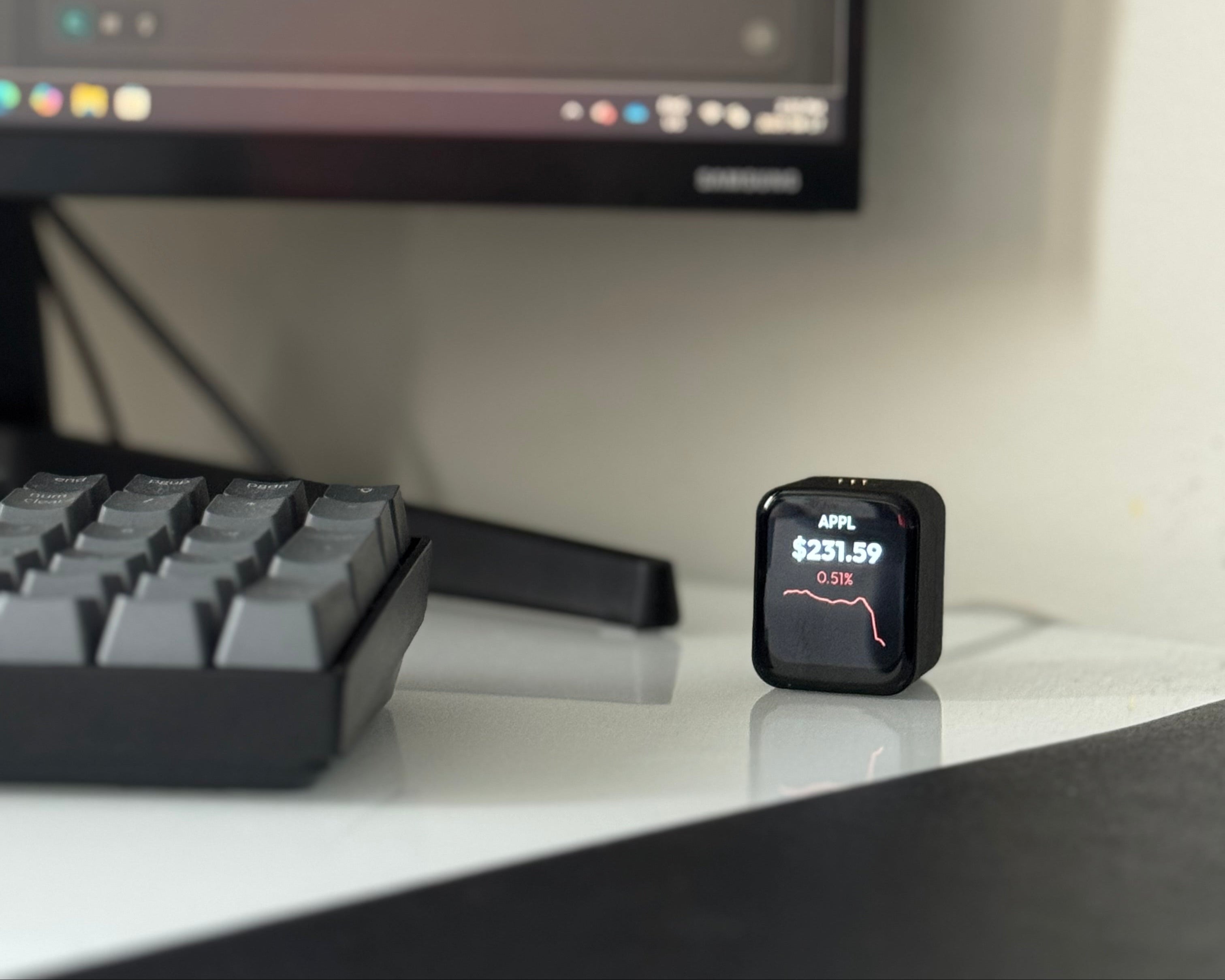 Wealth Tracker on desk with monitor