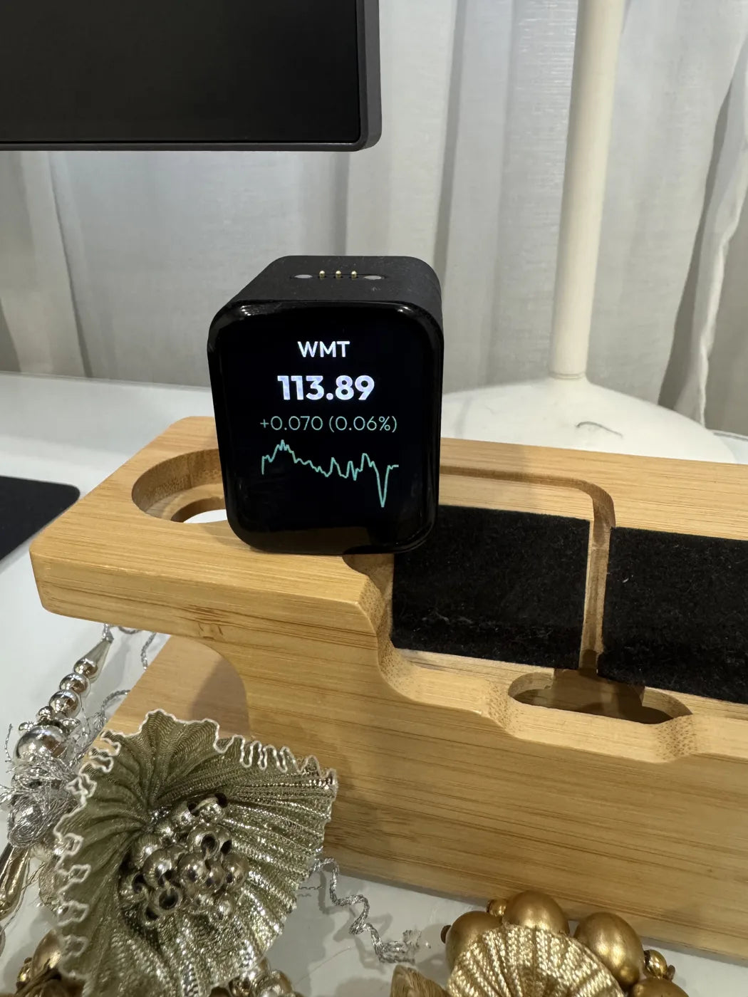 Wealth Tracker on a wooden desk shelf